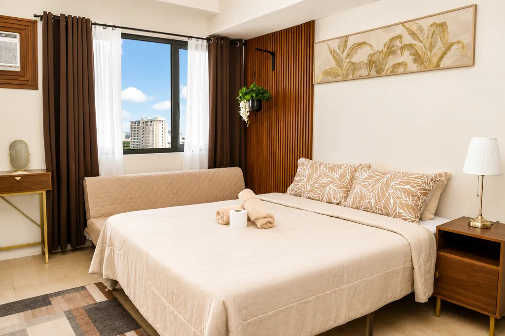 Bed beside the window, looking out over the city