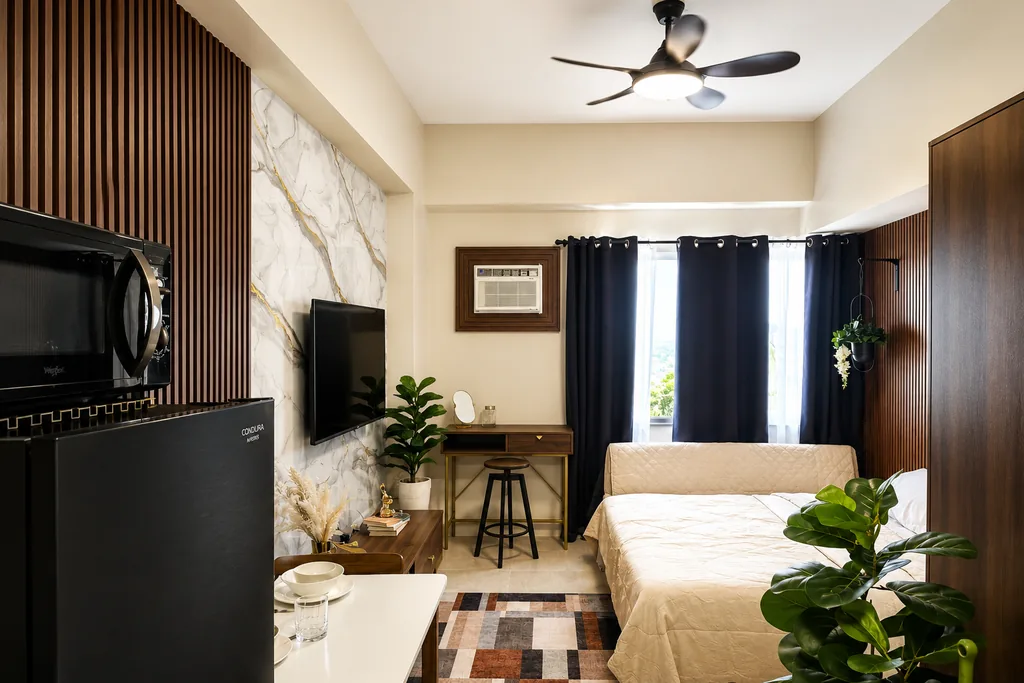 The studio: bed, desk nook, kitchen and dining in one room