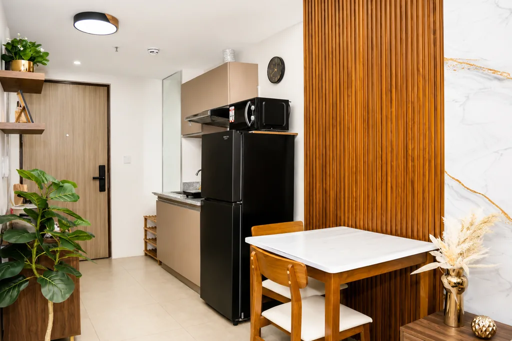 Dining table beside the kitchenette and the entrance